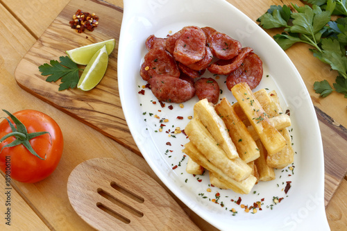 Sausage with fried yuca photo