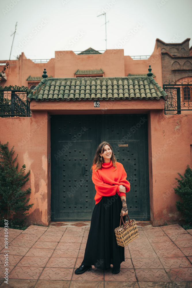 Young woman with red wool pullover and bag