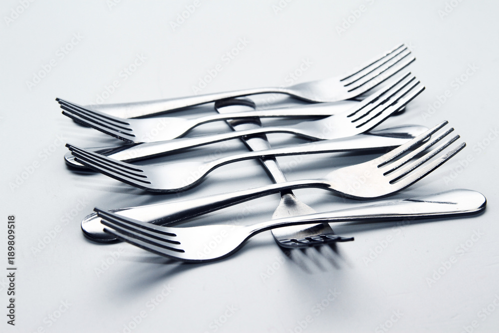 Fork background / A fork, in cutlery or kitchenware, is a tool consisting of a handle with several narrow tines on one end. Fork background / A fork, in cutlery or kitchenware, is a tool consisting of a handle with several narrow tines on one end.