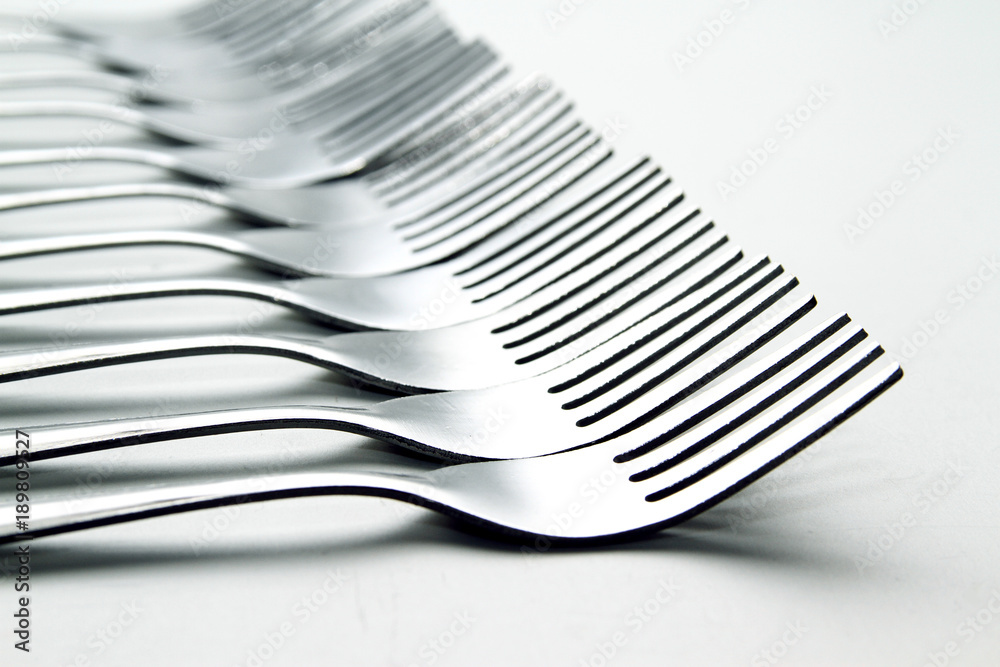 Fork background / A fork, in cutlery or kitchenware, is a tool consisting of a handle with several narrow tines on one end. Fork background / A fork, in cutlery or kitchenware, is a tool consisting of a handle with several narrow tines on one end.