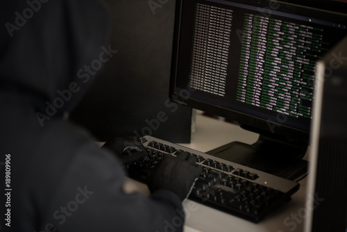 Hacker working on a code with attack the server in the dark photo