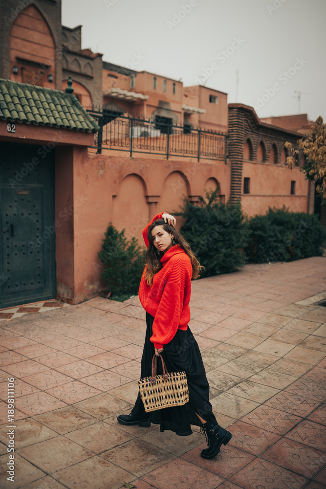 Young woman with red wool pullover and bag