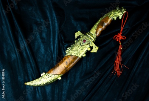 Konstfotografi old dagger on black cloth