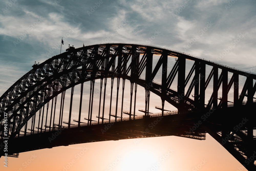 Naklejka premium Close up view of Sydney Harbour Bridge during sunset.