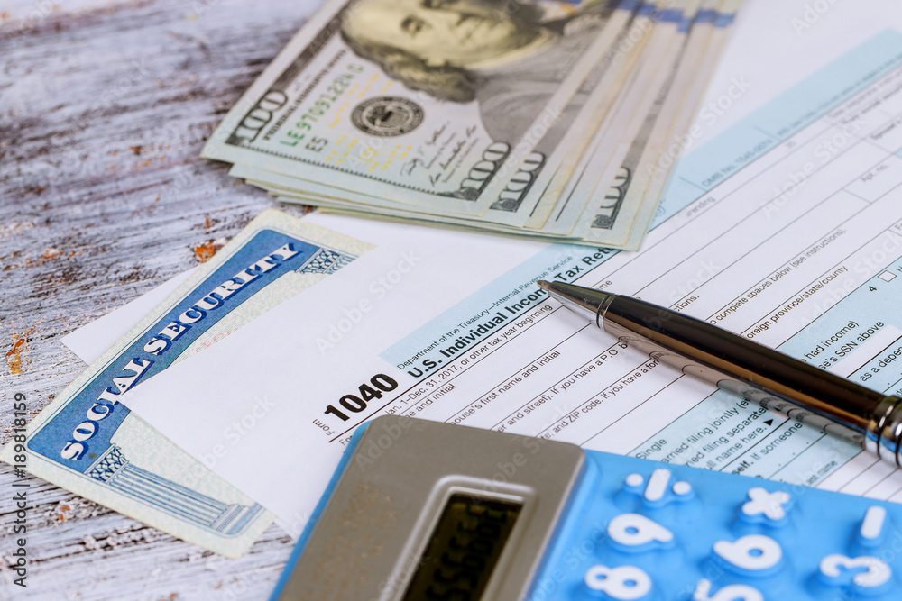 Fototapeta premium Calculating numbers for income tax return with calculator