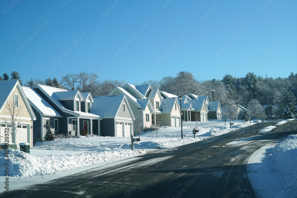 Fototapeta premium Modern houses in a row in residential area after snow storm