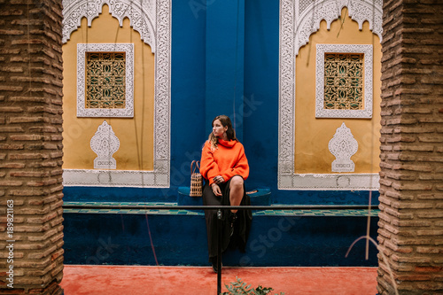 Woman in an arabic environment. Woman in a muslim environment. Tourist walking down street of Marrakech.