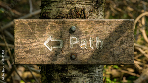 Sign: Path, bolted on a tree, seen in Grass Wood near Conistone, North Yorkshire, UK photo