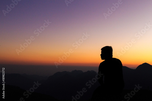 Man with arms extended toward heaven at sunrise ,success or prayer concept