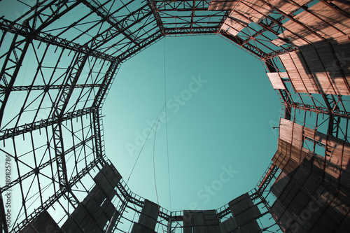 View of the sky from a dilapidated cooling tower