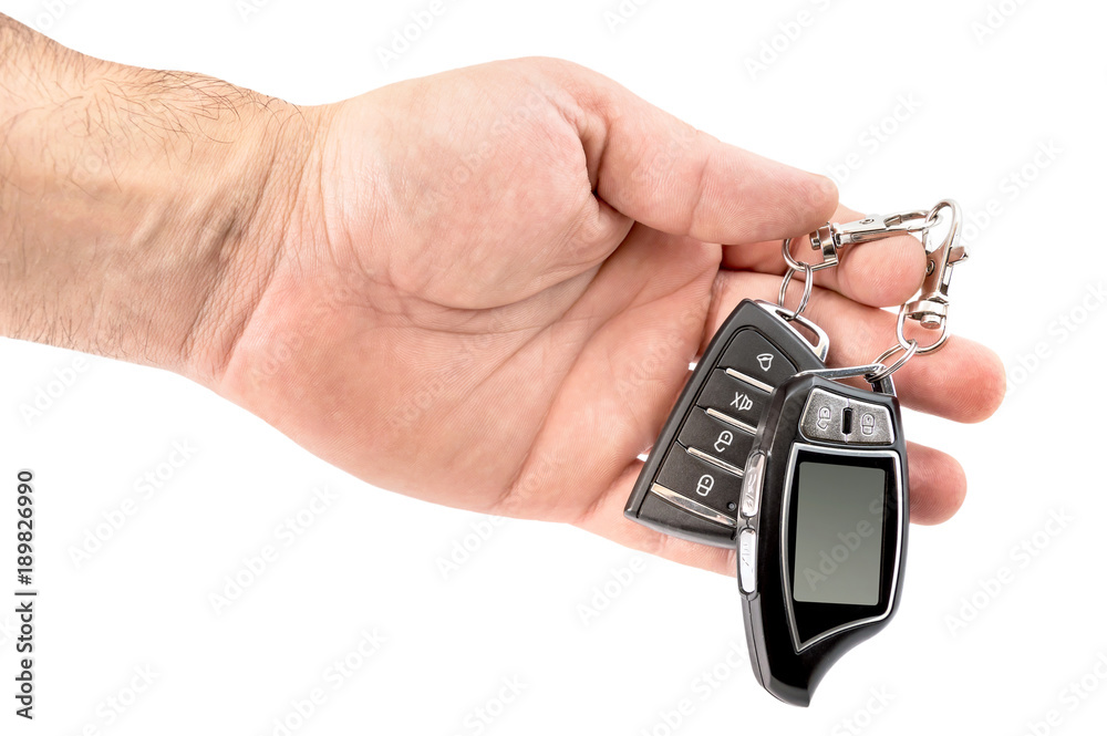 Hand holding car remote control. Isolated on white. Hand holding car remote control. Isolated on white.
