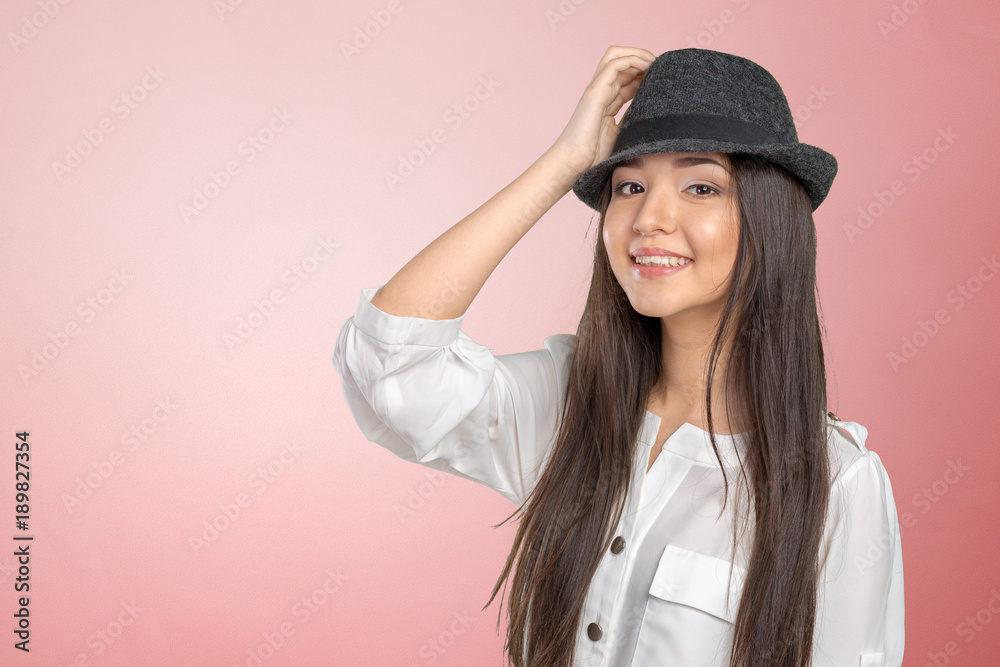 Beautiful young woman wearing summer fedora straw hat posing Beautiful young woman wearing summer fedora straw hat posing