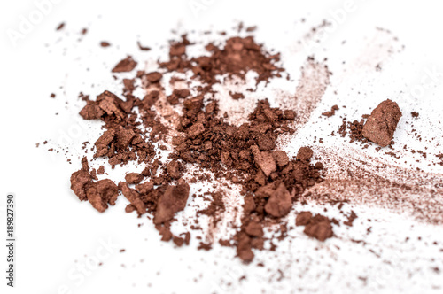 Brown crushed eye shadows on white background. Close up.