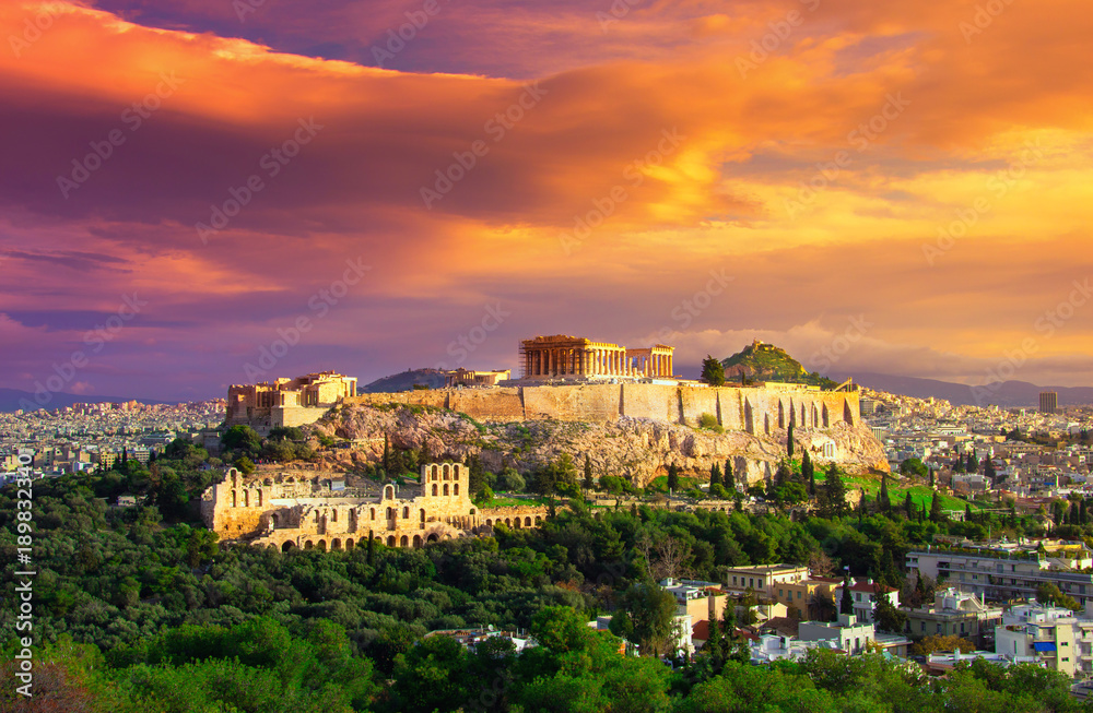 Acropolis with Parthenon. View through a frame with green plants, trees, ancient marbles and cityscape, Athens, Greece.