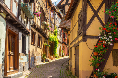 romantic alley in medieval town in Eguisheim, Alsace, France © lukaszimilena