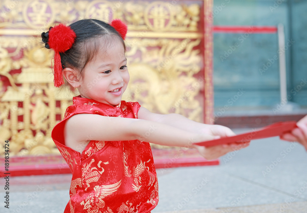 Happy little Asian girl received a red envelope. Chinese New Year celebration. Happy little Asian girl received a red envelope. Chinese New Year celebration.