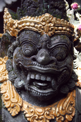 Traditional Balinese stone demon sculpture at Bali, Indonesia. © Raimonds  raymoonds