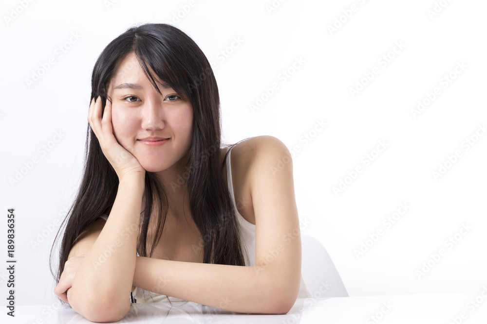 Pretty, happy, young woman in casual clothes sitting at the desk and looking up, isolated on white
Pretty, happy, young woman in casual clothes sitting at the desk and looking up, isolated on white
