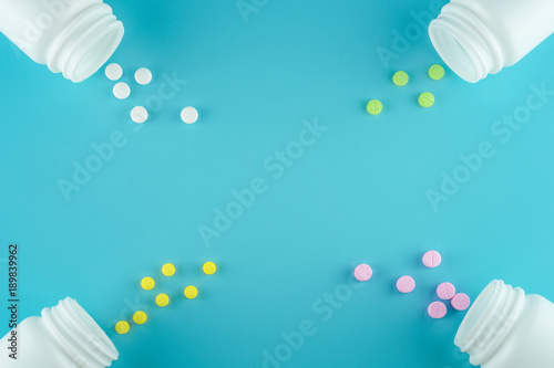 Medicines, supplements and drugs in a bottle on blue background