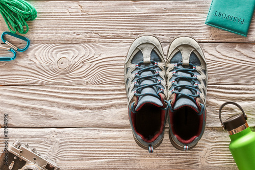 Travel items for hiking over wooden background