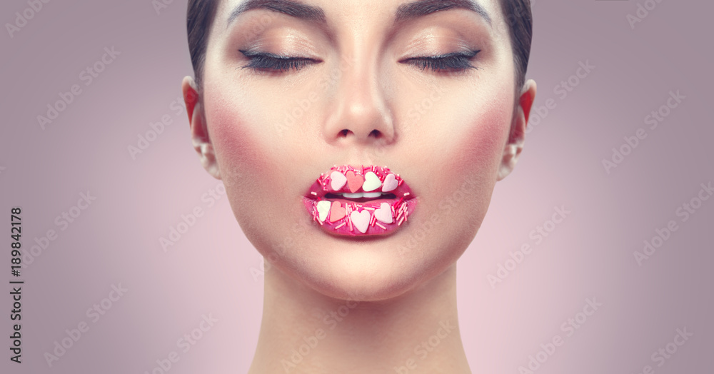 Valentine's Day makeup. Lips with pink hearts sugar sprinkles. Valentine hearts sweet makeup