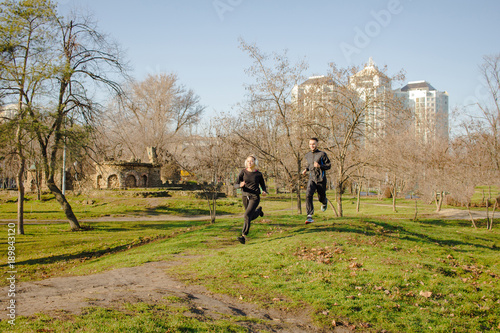couple of young runners training inautumn park  © serejkakovalev