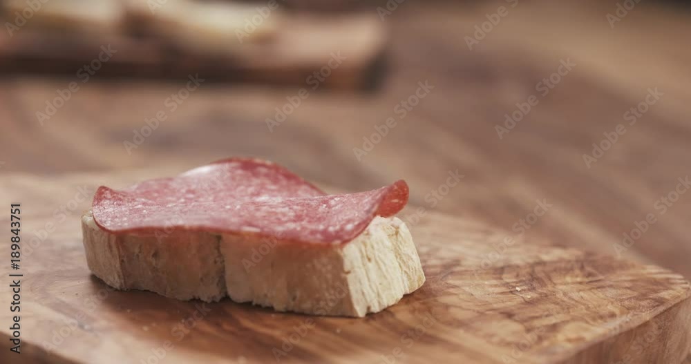 focus pull over sandwich with salami slices and cream cheese focus pull over sandwich with salami slices and cream cheese