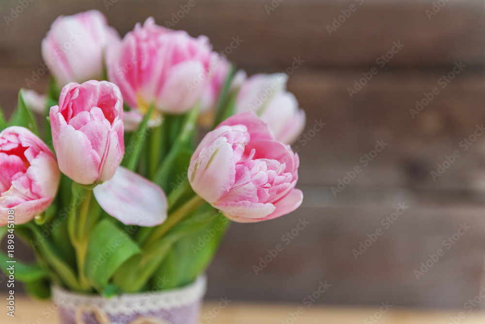 Bouquet of pink tulips over shabby wooden table. Spring greeting card happy mother day copy space Bouquet of pink tulips over shabby wooden table. Spring greeting card happy mother day copy space