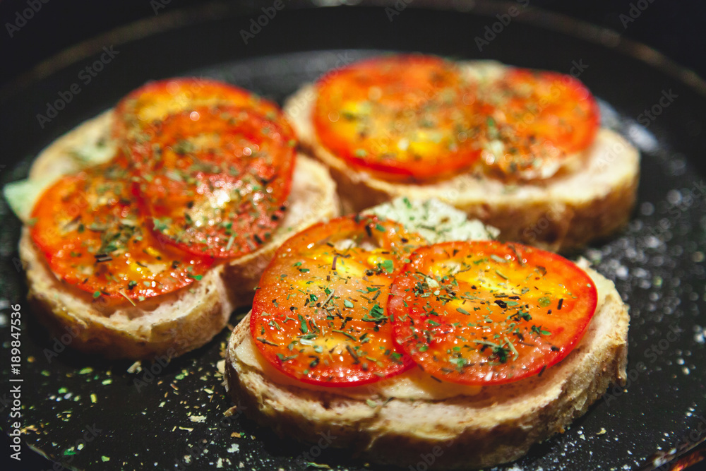 Three bruschettes with tomatoes lie on plate Three bruschettes with tomatoes lie on plate