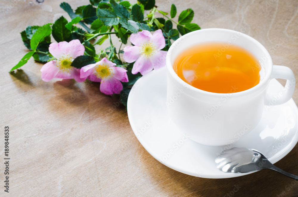 Cup of morning tea with lemon and delicate flowers Cup of morning tea with lemon and delicate flowers