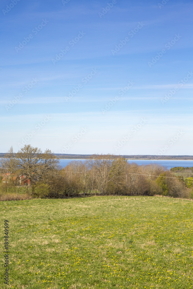 Fields in spring with a beautiful landscape view with a lake Fields in spring with a beautiful landscape view with a lake
