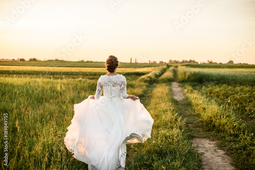 Happy and beautiful bride dance alone in nature