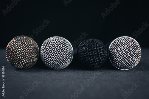 Gray on the table are microphones next to the remote, all on a black background