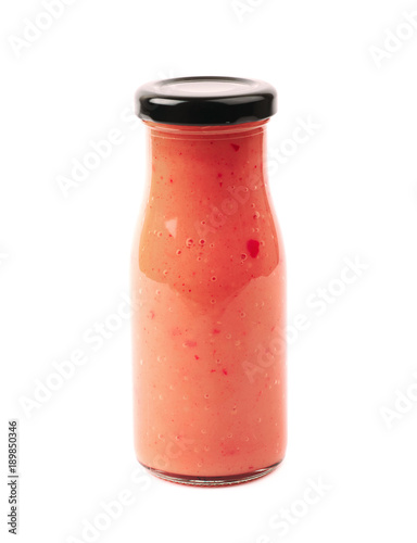 Red sauce in a glass bottle isolated