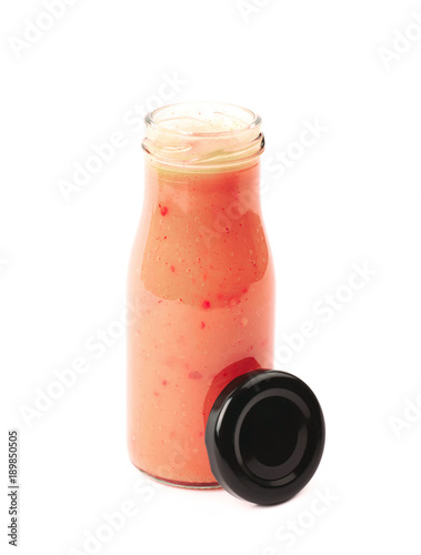 Red sauce in a glass bottle isolated
