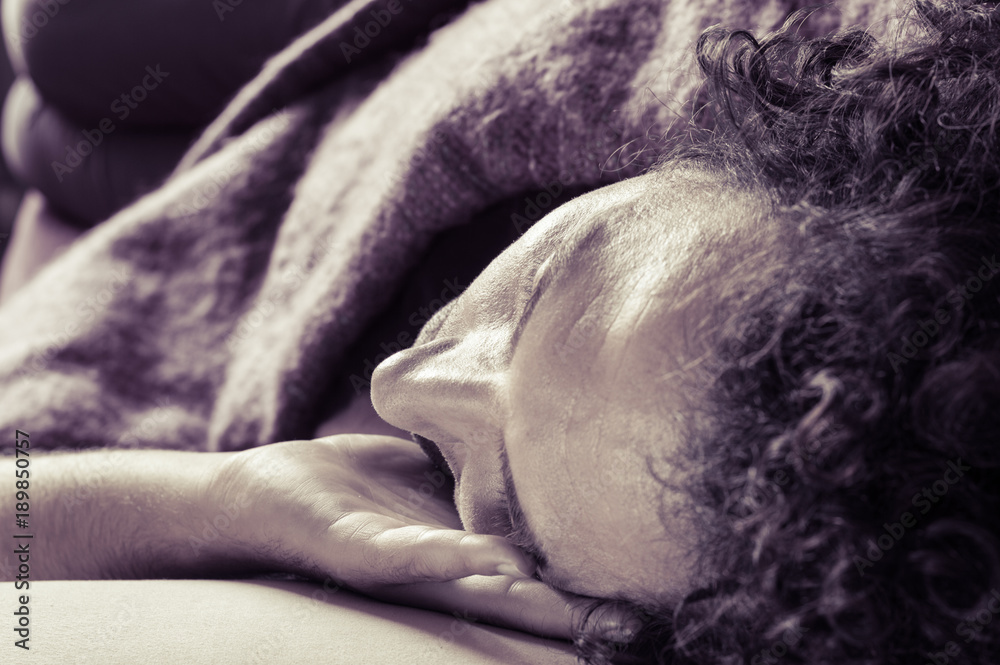 Fototapeta premium Young handsome man sleeping on sofa