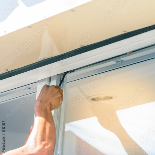 Obraz na plátně hand with screwdriver, tighten the screw stopper window.