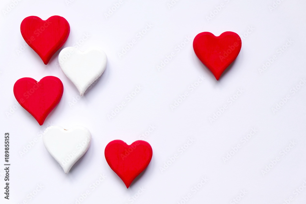 Top view of white and red wooden handcraft heart symbol  on white background.  Valentine's day theme.