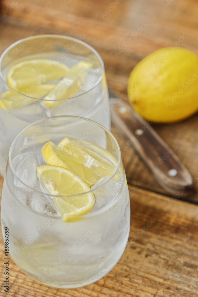 Fresh lemonade with ice and lemon on the table Fresh lemonade with ice and lemon on the table