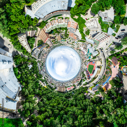 Aerial city view with crossroads and roads  houses  buildings  parks and parking lots  bridges. Helicopter drone shot. Wide Panoramic image.