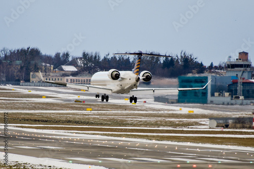 Jet plane is landing on runway at winter