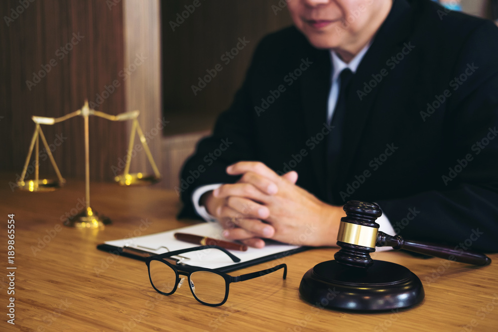Judge gavel with Justice lawyers, Businessman in suit or lawyer working on a documents. Legal law, advice and justice concept Judge gavel with Justice lawyers, Businessman in suit or lawyer working on a documents. Legal law, advice and justice concept