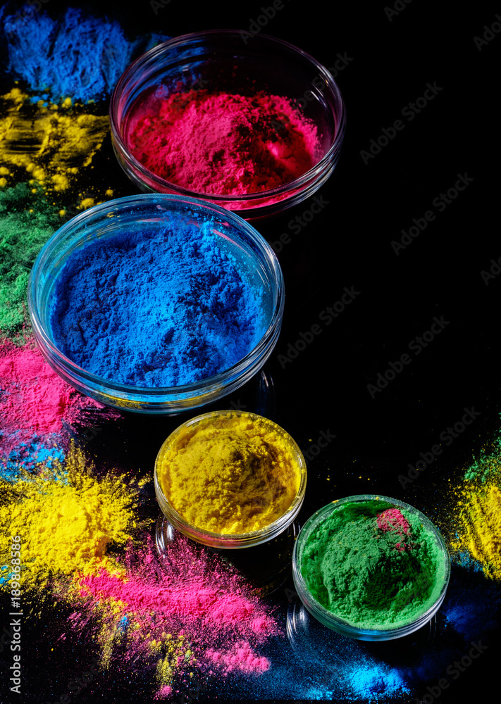 Photo & Art Print Indian Holi festival colours in four bowls on dark  background