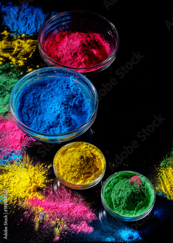 Fotografie Indian Holi festival colours in four bowls on dark background