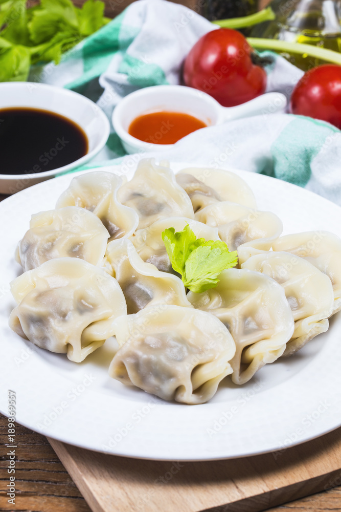 Asian dumplings in bowl, chopsticks, Chinese dumplings for dinner. Chinese dumplings for dinner/lunch. Traditional Asian/Chinese cuisine. Asian dumplings in bowl, chopsticks, Chinese dumplings for dinner. Chinese dumplings for dinner/lunch. Traditional Asian/Chinese cuisine.