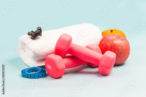 Sports shoes, dumbbell fitness in the blue background. Different sports tools