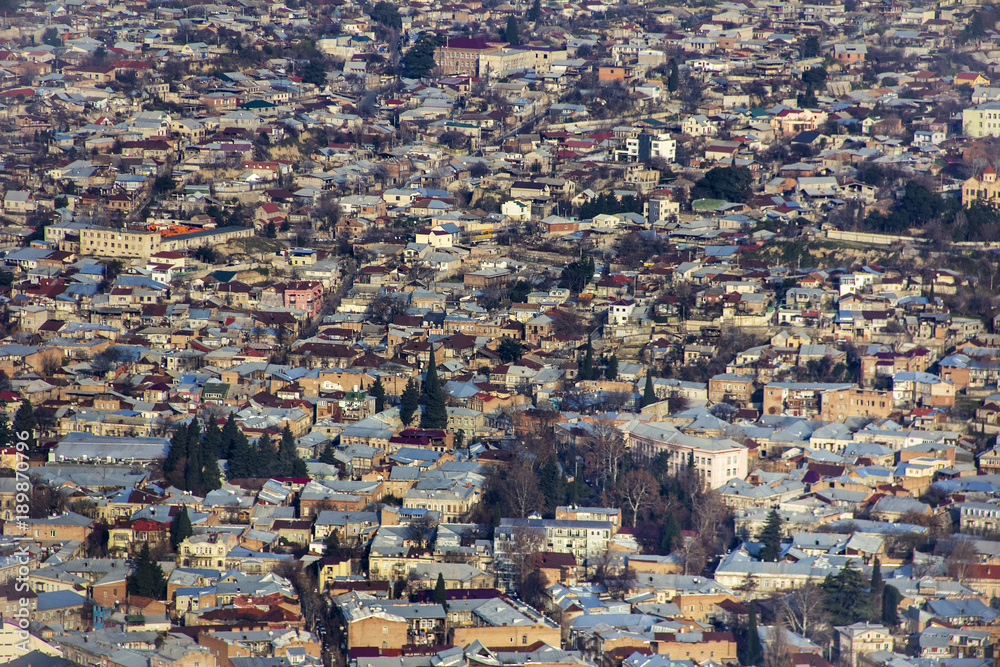 View of the city of Tbilisi, its tiled roofs and colorful houses from the viewpoint of the hill