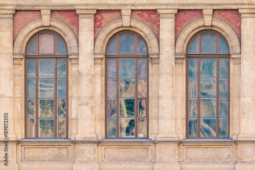 Three windows in a row on the facade of the urban historic building front view, Saint Petersburg, Russia 
