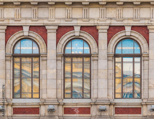 Three windows in a row on the facade of the urban historic building front view, Saint Petersburg, Russia
