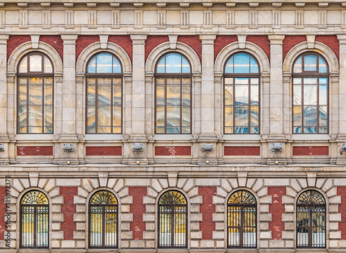 Several windows in a row on the facade of the urban historic building front view, Saint Petersburg, Russia
